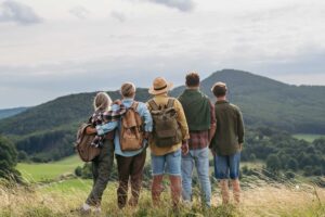 Familia en frente de una montaña en el campo mientras viajan